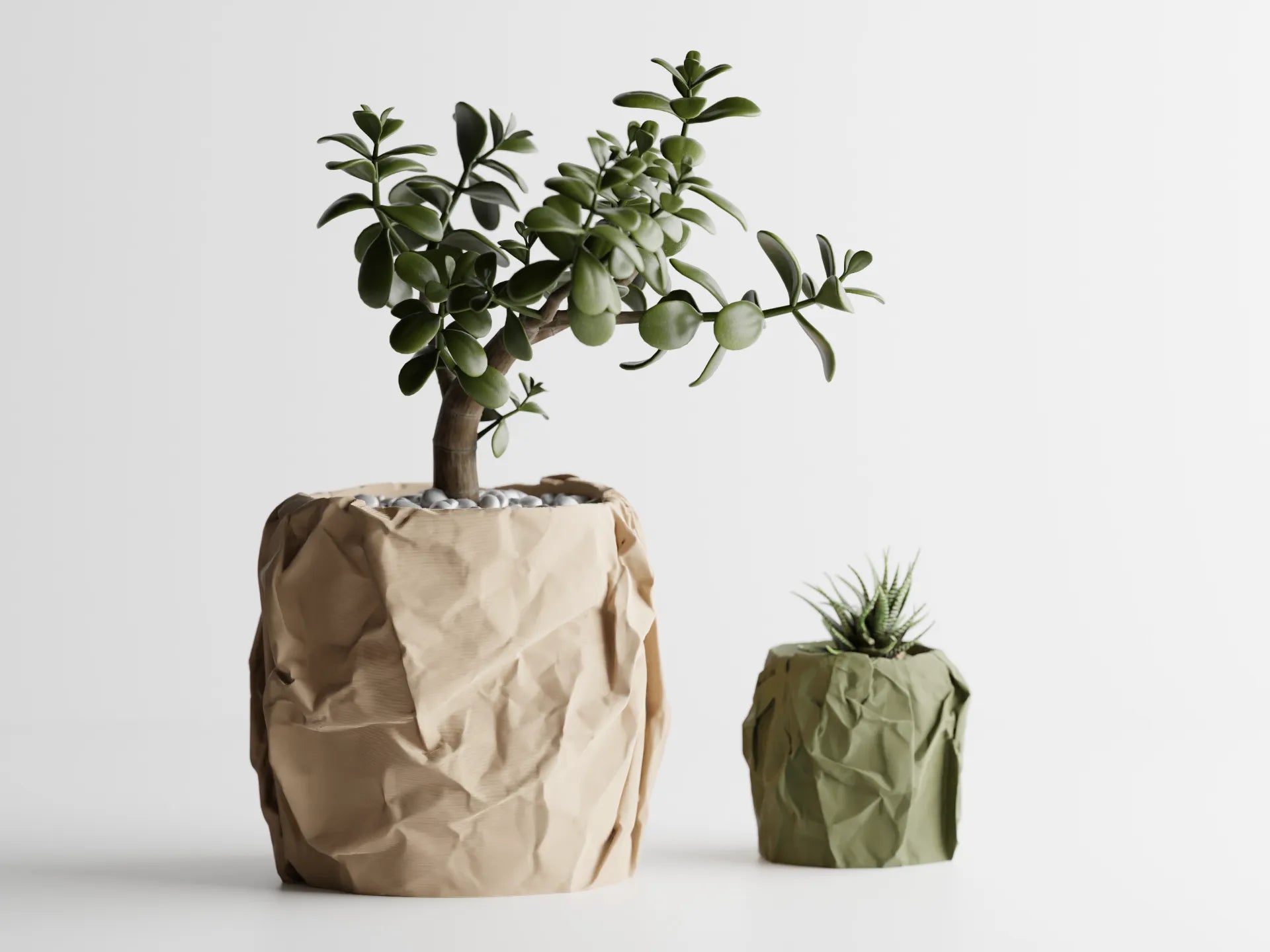 Two 3D printed planters styled like crumpled fabric, one in brown and one in green, holding succulents on a white background